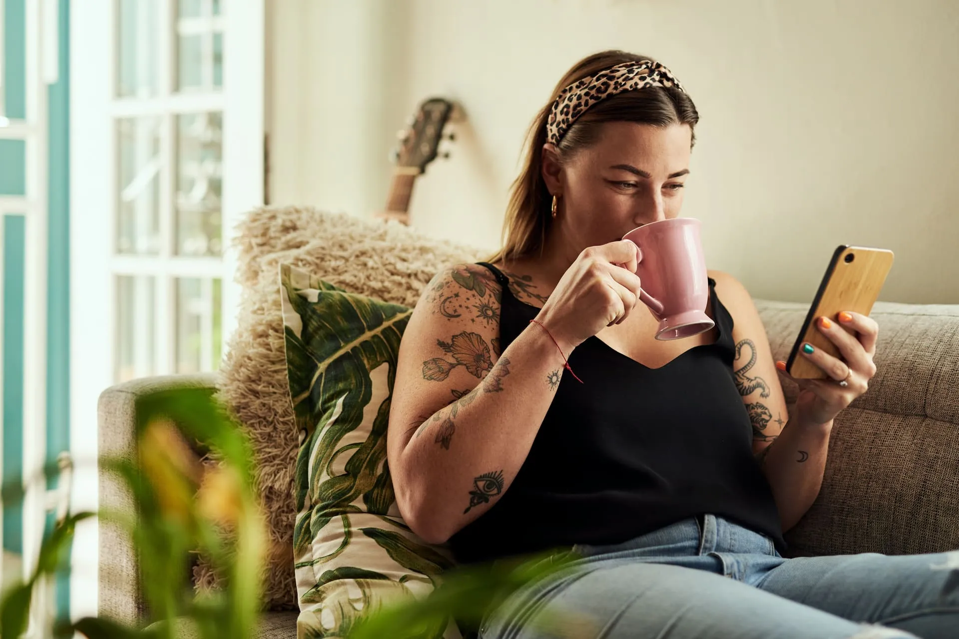 Woman in her early forties looking out a window in soft afternoon light